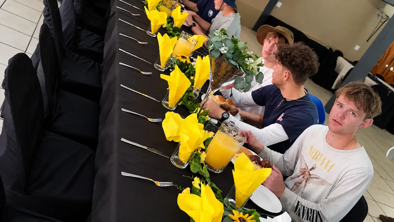 Learners preparing and serving food together